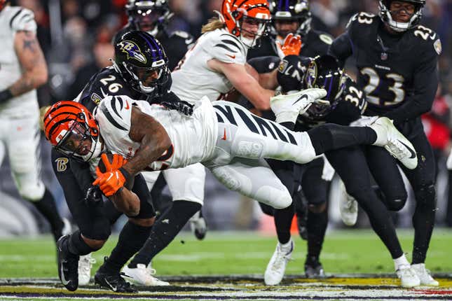 BALTIMORE, MARYLAND - NOVEMBER 16: Joe Mixon #28 of the Cincinnati Bengals is tackled by Geno Stone #26 of the Baltimore Ravens during the first quarter at M&amp;T Bank Stadium on November 16, 2023 in Baltimore, Maryland. (Photo by Patrick Smith/Getty Images)