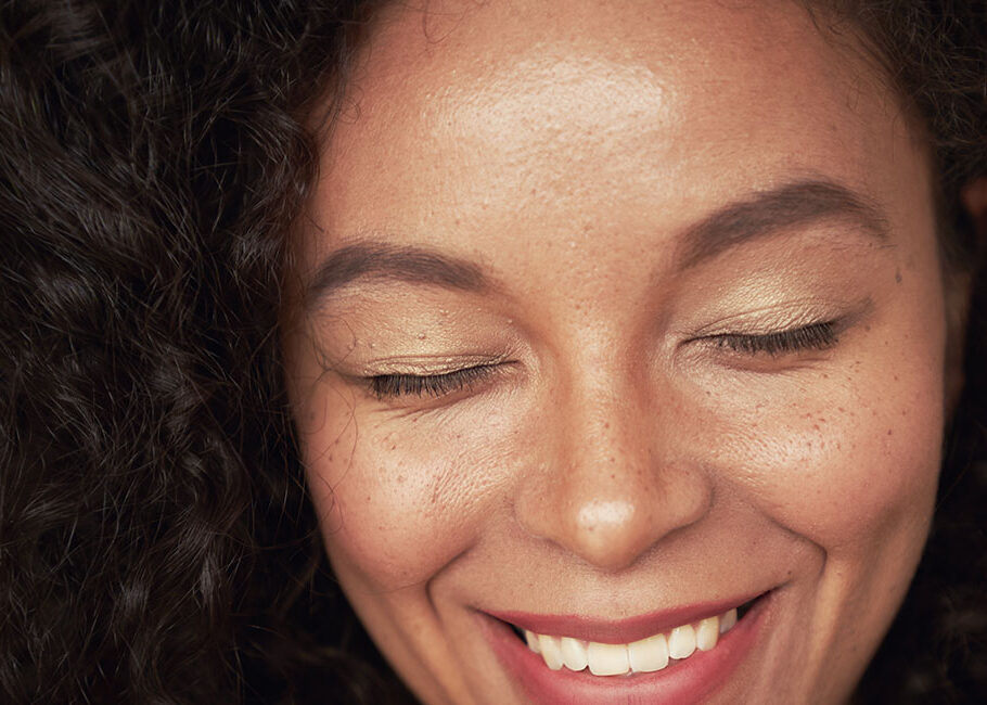 woman smiling with eye closed